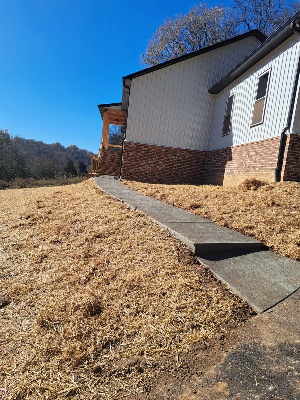 Walkway route laid out across graded ground toward the entry