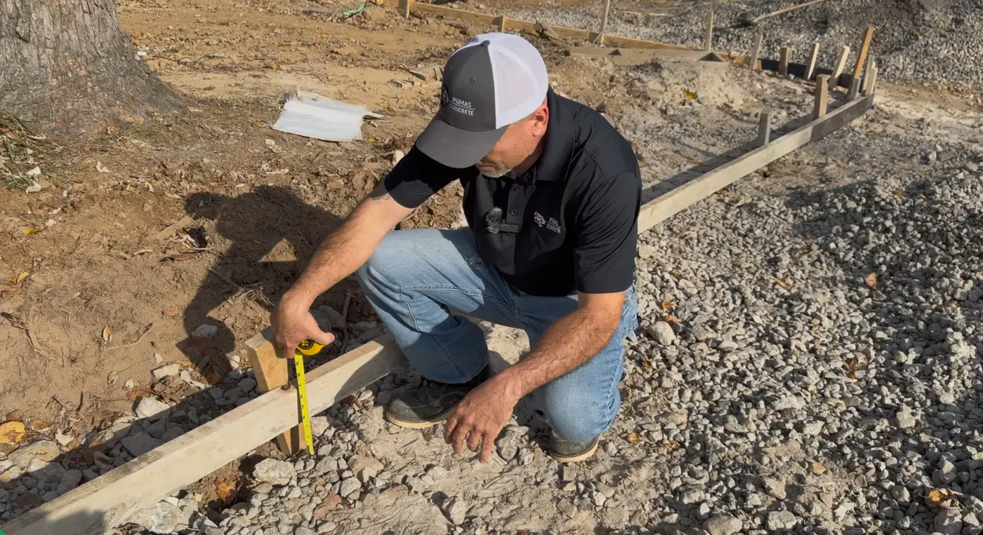 Measuring and checking grade across a slab footprint before excavation