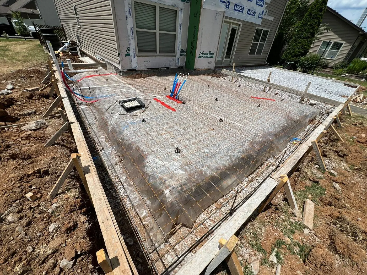 Formed patio slab with vapor barrier and rebar in place before concrete